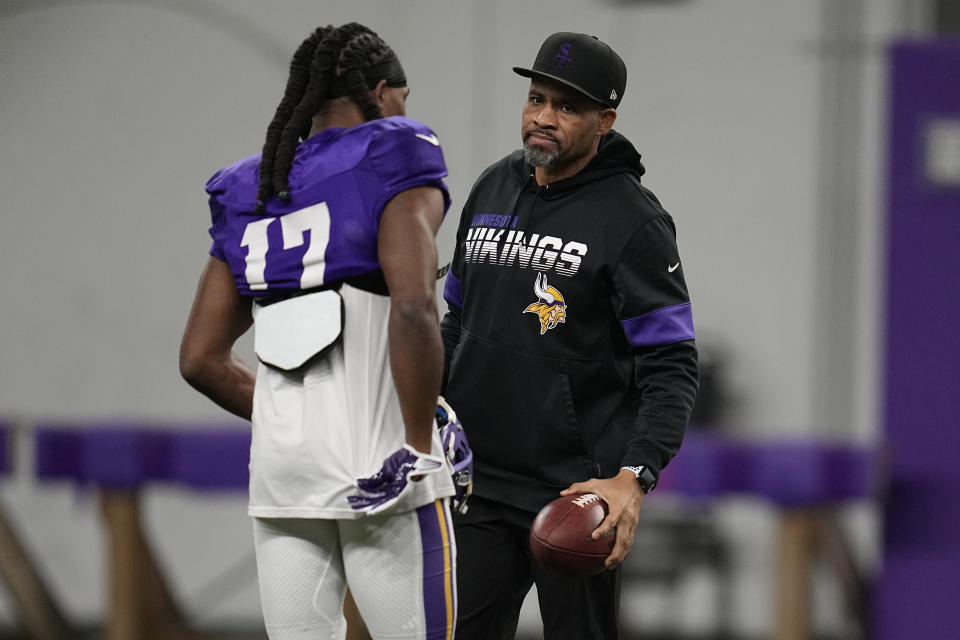 Minnesota Vikings wide receiver K.J. Osborn (17), left, and wide receivers coach Keenan McCardell talk during an NFL football team practice in Eagan, Minn., Thursday, Jan. 12, 2023. The Vikings are to play the New York Giants in a wild-card game on Sunday. (AP Photo/Abbie Parr)
