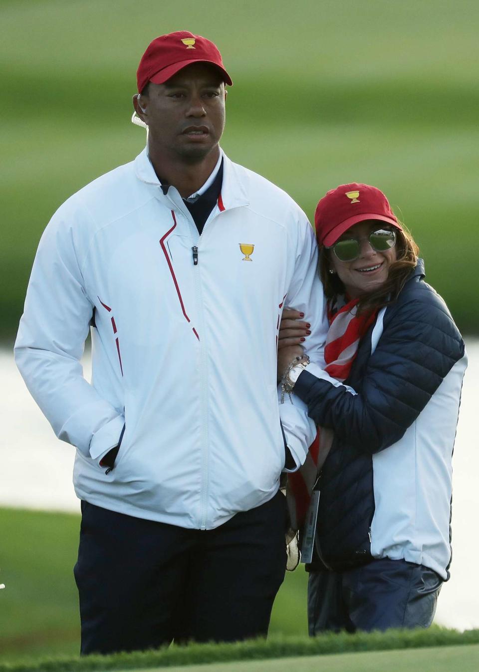 Tiger Woods of the U.S. Team and Erica Herman look on during Saturday four-ball matches of the Presidents Cup at Liberty National Golf Club on September 30, 2017 in Jersey City, New Jersey. (Photo by Rob Carr/Getty Images)