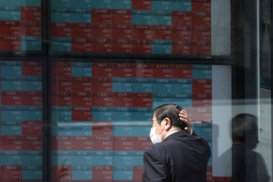FILE - A person looks at an electronic stock board showing Japan's stock princes at a securities firm Tuesday, April 2, 2024, in Tokyo. Asian shares mostly declined Friday, April 5, after a U.S. Federal Reserve official said the central bank might not deliver any of the interest rate cuts that Wall Street has been banking on this year, citing concerns about inflation. (AP Photo/Eugene Hoshiko, File)