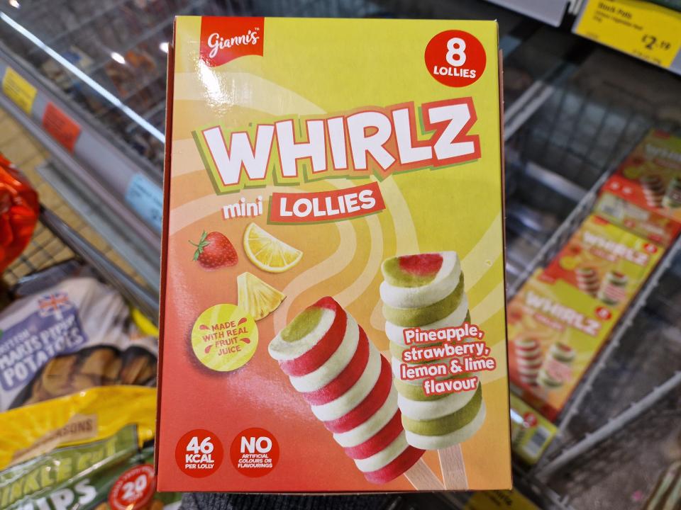 The writer holds a box of Whirlz lollipops