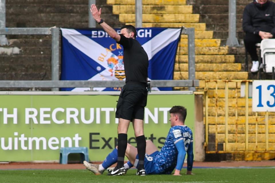 Referee Thomas Reeves beckons Carlisle's physios with Jack Robinson down injured <i>(Image: Ben Holmes)</i>