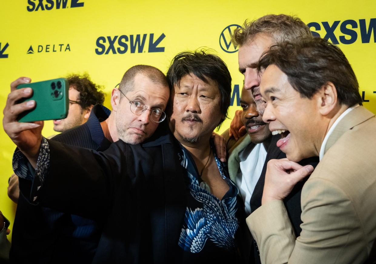 Benedict Wong, center, takes a selfie with D.B. Weiss, left, Jovan Adepo, David Benioff, and Alexander Woo on the red carpet at the premiere of "3 Body Problem" at the Paramount Theatre on the first day of South by Southwest, Friday, March 8, 2024