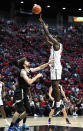 San Diego State forward Nathan Mensah (31) shoots over Occidental forward Bernard Cassidy during the first half of an NCAA college basketball game Friday, Dec. 2, 2022, in San Diego. (AP Photo/Denis Poroy)