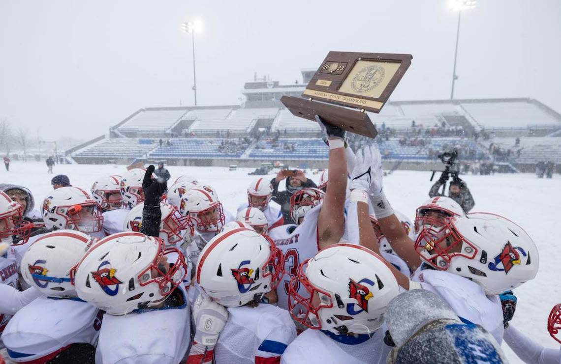 The Cheney football team celebrates with its first state championship in school history after completing a perfect 13-0 season with a 34-7 win over Topeka Hayden in the Class 3A state finals.