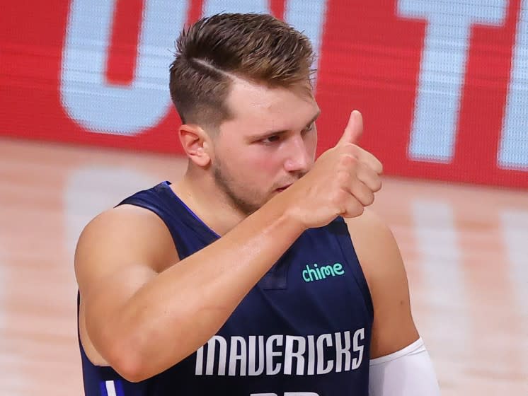 Dallas Mavericks' Luka Doncic gives a thumbs-up during the second quarter of Game 4 of an NBA basketball first-round playoff series against the Los Angeles Clippers, Sunday, Aug. 23, 2020, in Lake Buena Vista, Fla. (Kevin C. Cox/Pool Photo via AP)