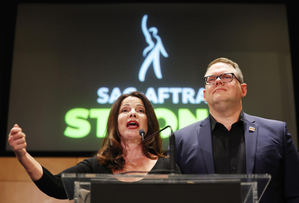 LOS ANGELES, CALIFORNIA - NOVEMBER 10: SAG-AFTRA President Fran Drescher (L) speaks as SAG-AFTRA National Executive Director Duncan Crabtree-Ireland looks on at a press conference discussing their strike-ending deal with the Hollywood studios on November 10, 2023 in Los Angeles, California. A tentative labor agreement has been reached between the actors union and the Alliance of Motion Picture and Television Producers (AMPTP) with the strike completed after 118 days. (Photo by Mario Tama/Getty Images)