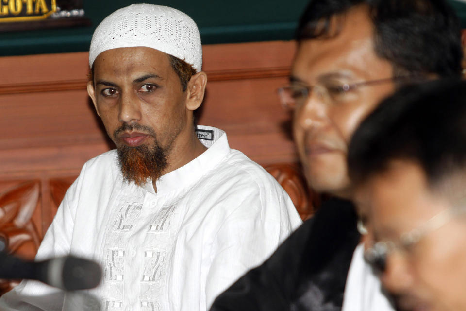 FILE - Umar Patek, an Indonesian militant charged in the 2002 Bali terrorist attacks, left, sits with his lawyer during his trial in Jakarta, Indonesia, Thursday, March 8, 2012. Australian Prime Minister Anthony Albanese said Friday, Aug. 19, 2022, that it's upsetting Indonesia has further reduced the prison sentence of the bombmaker Patek in the Bali terror attack that killed 202 people — meaning the terrorist could be freed within days if he's granted parole. (AP Photo/Tatan Syuflana, File)