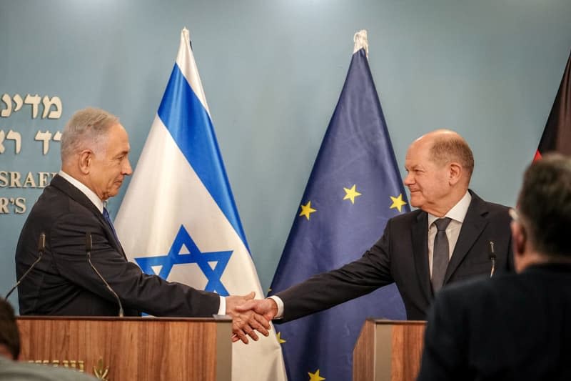 German Chancellor Olaf Scholz and Israeli Prime Minister Benjamin Netanyahu shake hands after a joint press conference. Scholz is scheduled to meet Israeli President Isaac Herzog and War Cabinet Minister Benny Gantz as well as relatives of Israeli hostages held in Gaza alongside Netanyahu. Kay Nietfeld/dpa