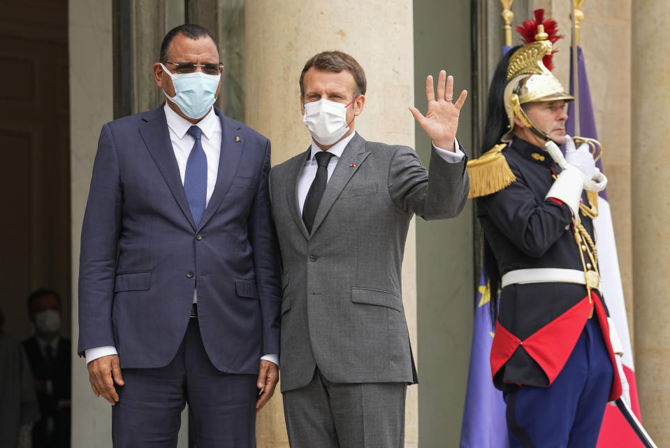 Niger's President Mohamed Bazoum, left, is welcomed by France's President Emmanuel Macron for a video-summit with leaders of the G5 Sahel at the Elysee Palace, Friday, July 9, 2021. (AP Photo/Michel Euler)