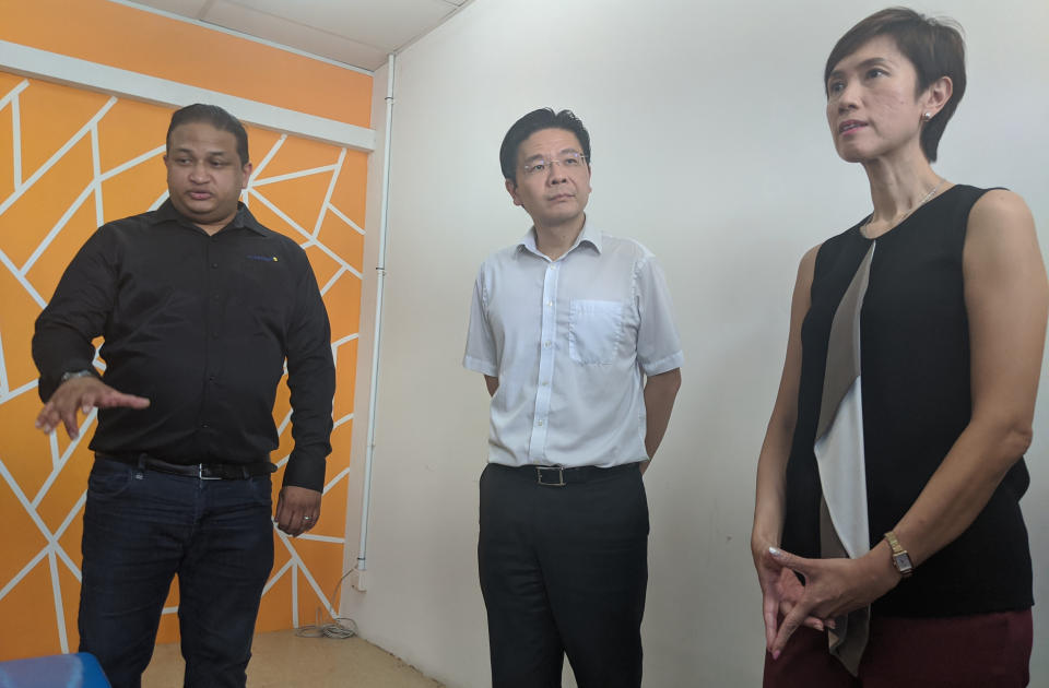 From left to right: CEO of Dormitory operator TS Group Shamkumar Subramani on a tour of an isolation room at Tuas View Dormitory, along with National Development Minister Lawrence Wong and Manpower Minister Josephine Teo on 6 February, 2020. (PHOTO: Yahoo News Singapore)