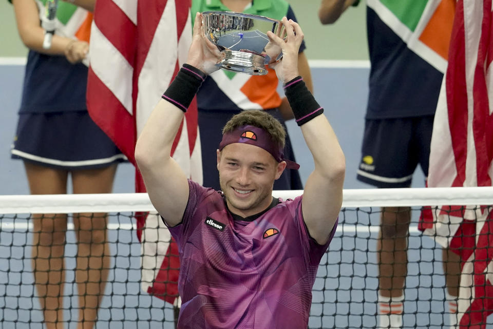 Alfie Hewitt, of Britain, holds up the championship trophy after defeating Shingo Kunieda, of Japan, in the men's wheelchair singles final of the U.S. Open tennis championships, Sunday, Sept. 11, 2022, in New York. (AP Photo/Mary Altaffer)