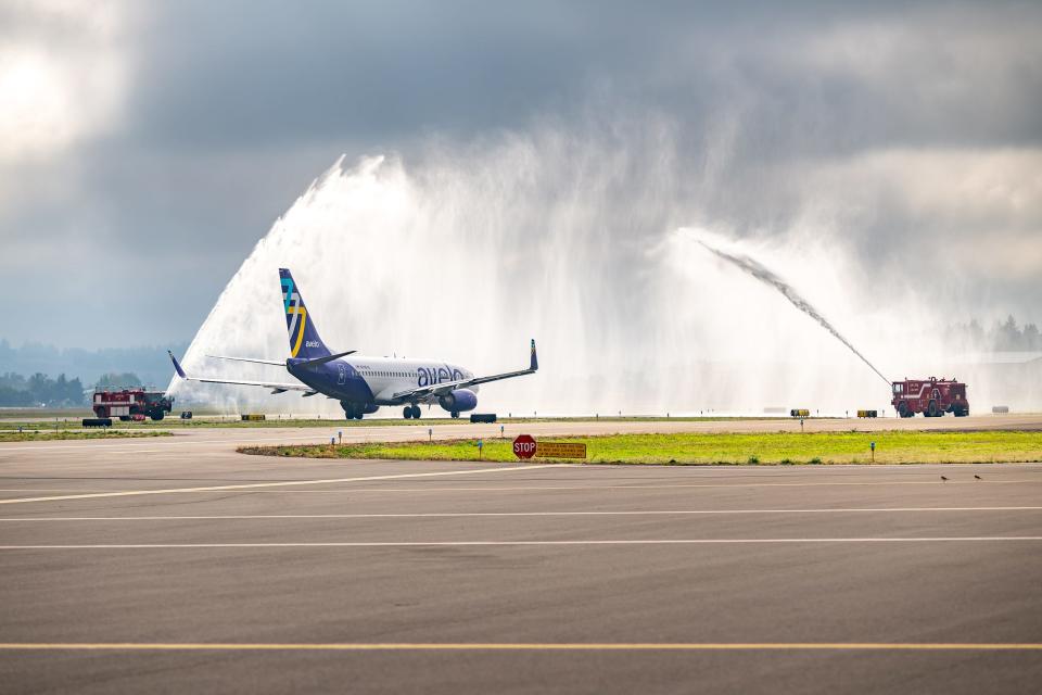 The inagural flight of Avelo Airlines, the first commercial flight out of Salem in more than a decade, is celebrated with a water spray from the Salem Fire Department.