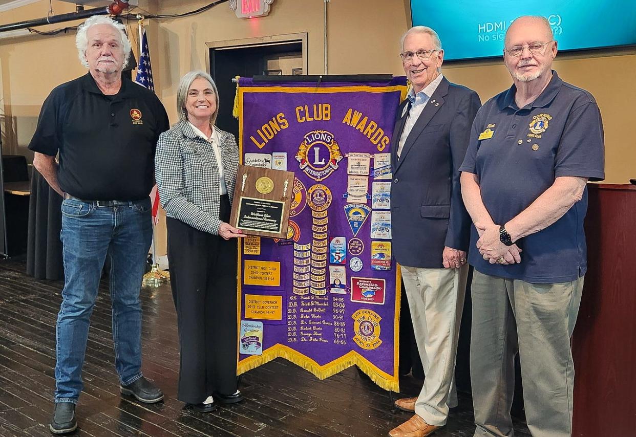 Watkins Glen International Racetrack President Dawn Burlew accepts the Robert J. Uplinger Distinguished Service Award Thursday night on behalf of the track for its support of the Corning Lions Club and the Greater Corning Area.