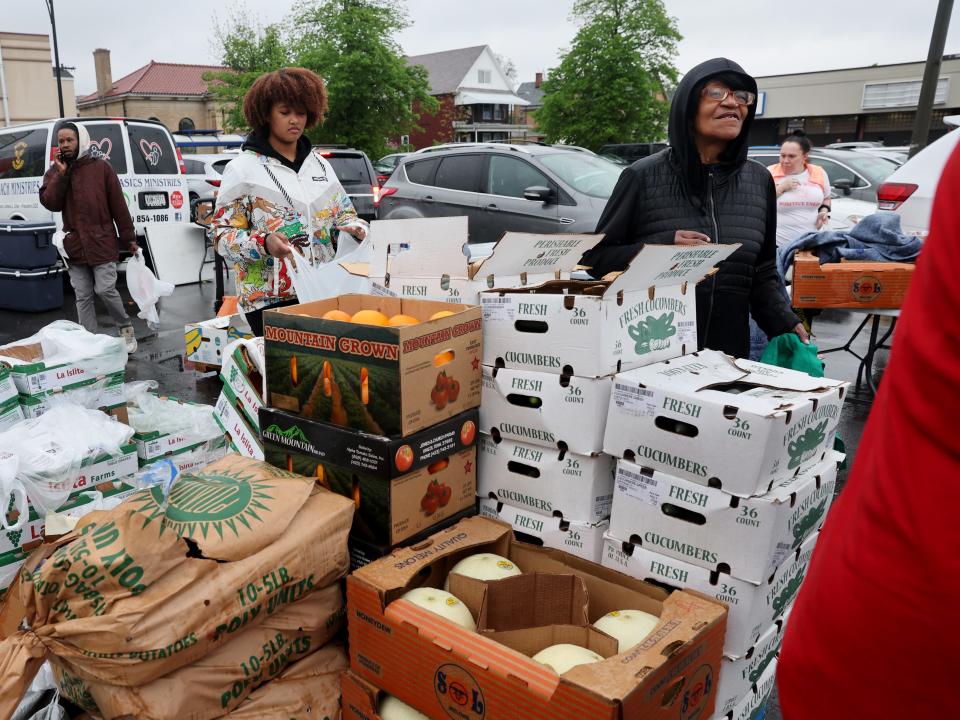 Workers with Rehoboth House of Prayer pass out donated groceries to residents living near the location of the Tops market shooting in Buffalo, New York