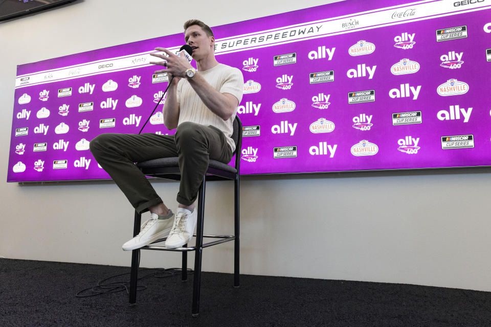 Two-time Indianapolis 500 winner Josef Newgarden speaks to reporters before a NASCAR Cup Series auto race, Sunday, June 30, 2024, in Gladeville, Tenn. (AP Photo/Wade Payne)