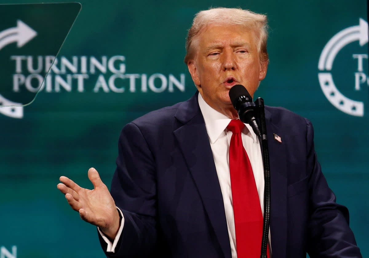 Donald Trump pictured speaking at Turning Point Action’s Believers’ Summit where he told Christians they’d never have to vote again (REUTERS)