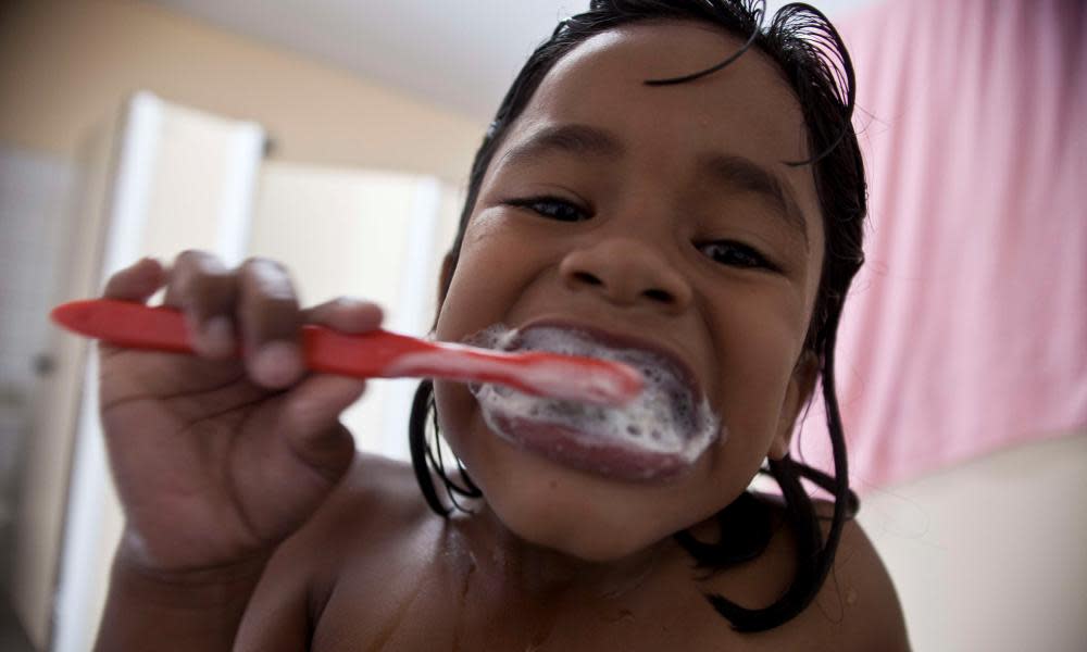 Young girl brushing her teeth