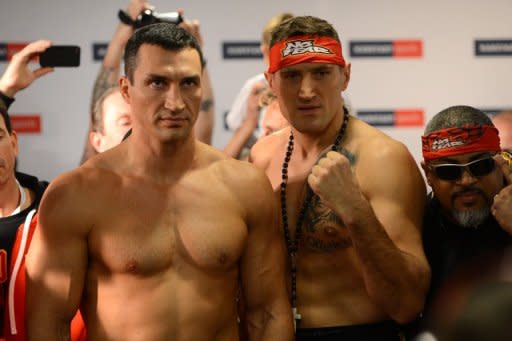 Ukrainian heavyweight boxing world champion Wladimir Klitschko (L) and challenger Polish Mariusz Wach pose during the official weigh-in, on November 9, in the nothern German city of Hamburg, on the eve of their fight