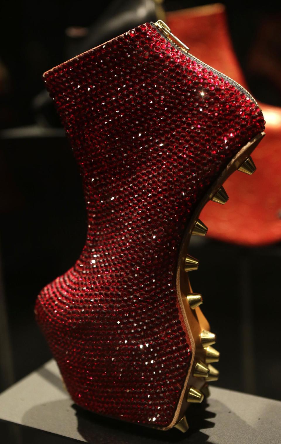 This Feb. 11, 2013 photo shows an avant-garde, sequined platform heel designed by Noritaka Tatehana displayed at the "Shoe Obsession" exhibit at The Museum at the Fashion Institute of Technology Museum in New York. The exhibition, showing off 153 specimens, runs through April 13. (AP Photo/Kathy Willens)