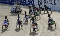 The field in race two start at the Addington Raceway in Christchurch, New Zealand, Thursday, May 28, 2020 in Christchurch, New Zealand, Thursday, May 28, 2020. New Zealand's financially troubled horse racing industry has reopened Thursday after being shuttered for weeks because of the coronavirus outbreak, leading the return of organized sports as the nation moves toward normality. A harness racing meeting which took place without fans at the Addington racecourse in Christchurch was the first since New Zealand went into strict lockdown on March 24. (AP Photo/Mark Baker)