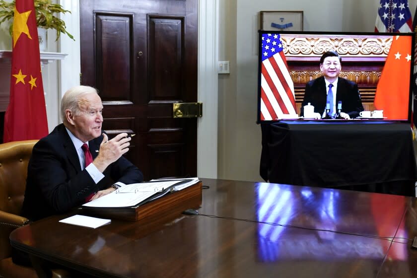 President Joe Biden meets virtually with Chinese President Xi Jinping from the Roosevelt Room of the White House in Washington, Monday, Nov. 15, 2021. (AP Photo/Susan Walsh)