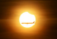 <p>An aeroplane flies past the sun as it goes into a partial solar eclipse in Singapore, March 9, 2016. (Photo: Edgar Su/Reuters) </p>