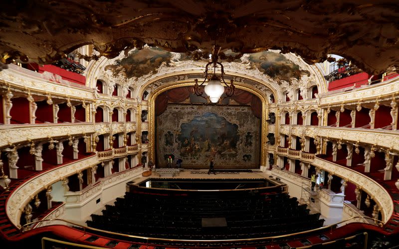 Workers are seen during a general renovation of Prague's State Opera building