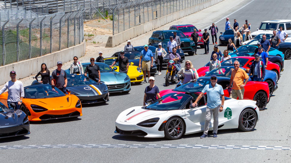 Participants pose on the track at Weathertech Raceway Laguna Seca during last year's Robb Report California Coastal road rally.