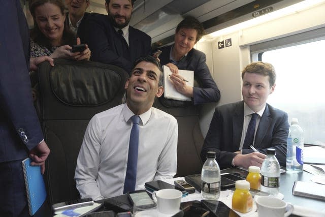 Rishi Sunak talks to the media as he journeys by train to Paris