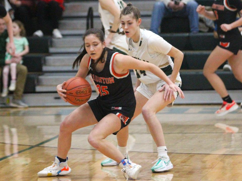 Taunton's Cali Melo makes a spin move while covered by Bishop Feehan's Mollie Mullen during a Division 1 Round of 16 game.