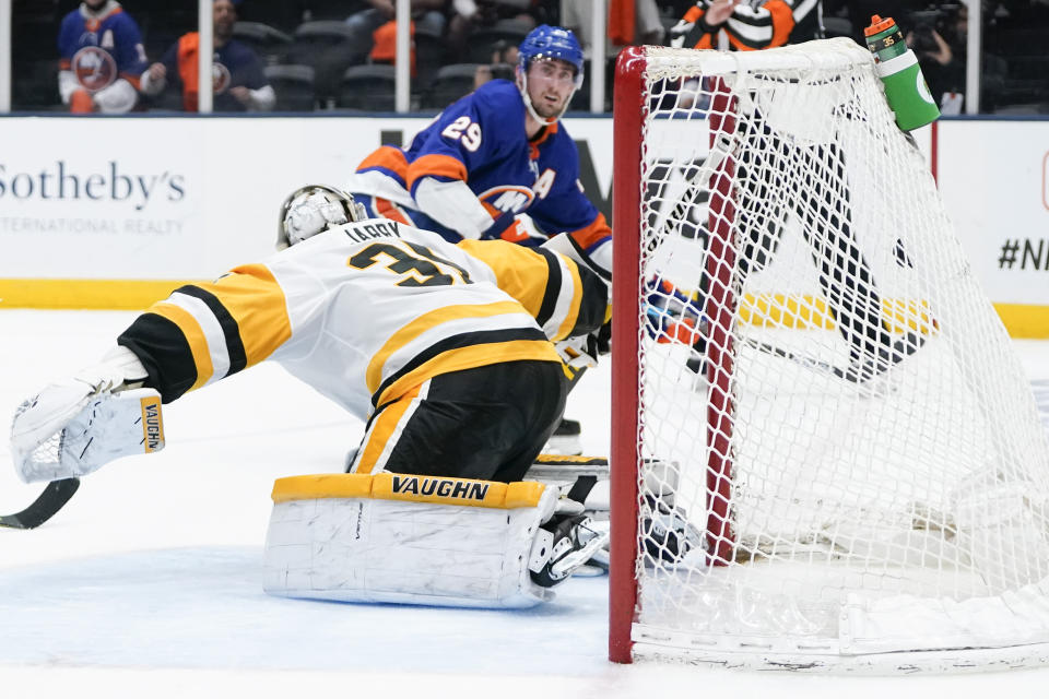 New York Islanders' Brock Nelson (29) watches his shot get past Pittsburgh Penguins goaltender Tristan Jarry (35) for a goal during the second period of Game 6 of an NHL hockey Stanley Cup first-round playoff series, Wednesday, May 26, 2021, in Uniondale, N.Y. (AP Photo/Frank Franklin II)