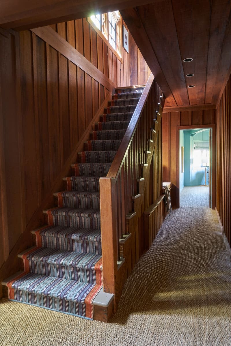 Wood paneled walls in entryway of home.