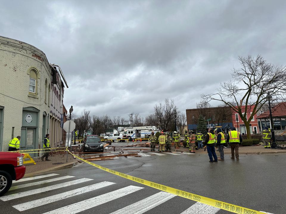 Firefighters, police and other village officials examine building damage in downtown Dundee caused by a severe thunderstorm that moved through the area Saturday morning, April 1, 2023.