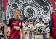 Leverkusen players celebrate their side's third goal during the German Bundesliga Soccer match between Eintracht Frankfurt and Bayer Leverkusen in Frankfurt, Germany, Sunday, May 5, 2024. (AP Photo/Michael Probst)