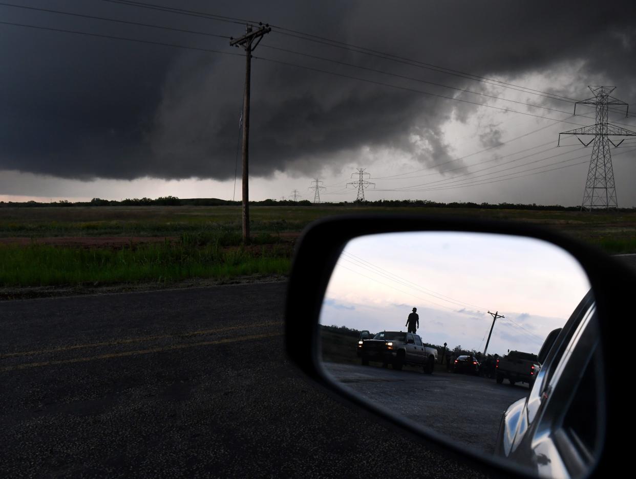 People watch the progress of the storm along U.S. 277 in Texas between Abilene and Hawley on May 2, 2024.