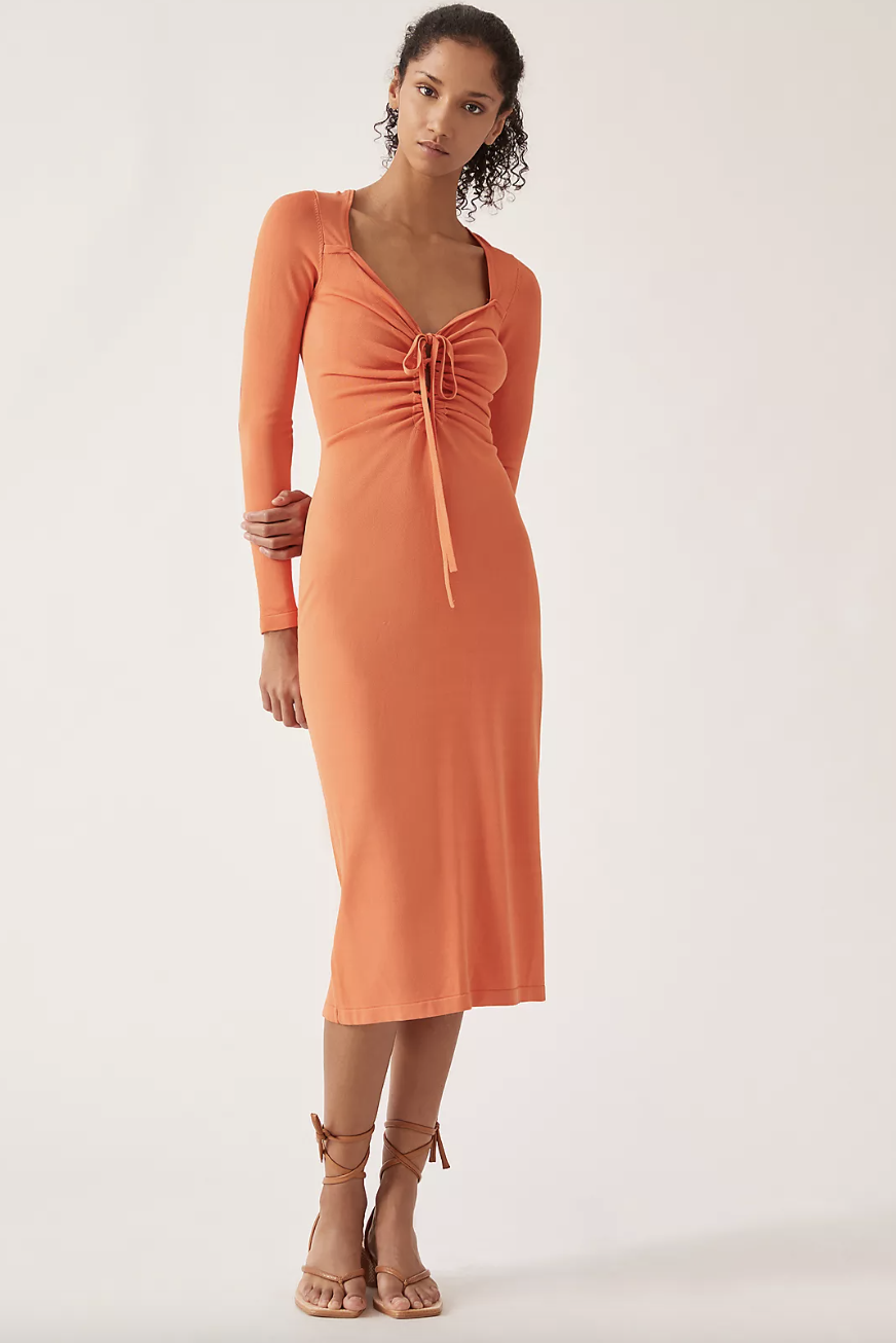 model in long sleeve orange dress Callahan Tie-Front Sweater Midi Dress (Photo via Anthropologie)