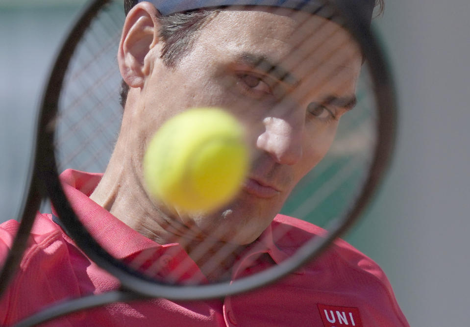 Switzerland's Roger Federer plays a return to Uzbekistan's Denis Istomin during their first round match on day two of the French Open tennis tournament at Roland Garros in Paris, France, Monday, May 31, 2021. (AP Photo/Thibault Camus)