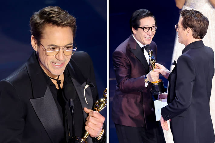 Two men on stage at an awards ceremony, one holding a trophy and interacting with the other