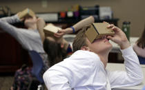 In this photo taken Tuesday, May 21, 2019, photo, Zane Taylor and other students use virtual reality technology to learn about the D-Day invasion at Normandy during a history class at Crossroads FLEX school in Cary, N.C. Its 75th anniversary brings extra classroom attention to D-Day, which has waned as a topic that’s emphasized in schools across the world. In a North Carolina classroom, students learn about spies, the deadly military practice before D-Day and a general who kept his plans "on the down low." (AP Photo/Gerry Broome)