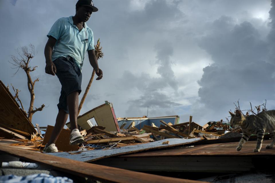 Jesner Merxius, an immigrant from Haiti, walks through the rubble in the aftermath of Hurricane Dorian in Abaco, Bahamas, Monday, Sept. 16, 2019. Dorian hit the northern Bahamas on Sept. 1, with sustained winds of 185 mph (295 kph), unleashing flooding that reached up to 25 feet (8 meters) in some areas. (AP Photo/Ramon Espinosa)