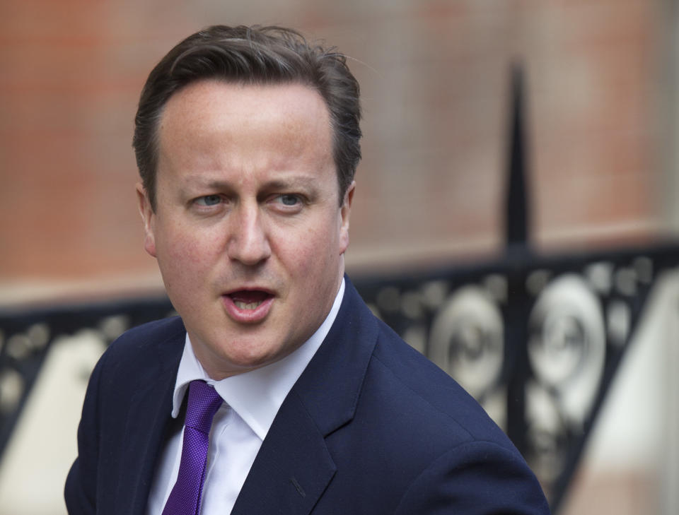 British Prime Minister David Cameron arrives to give evidence at the Leveson inquiry at the Royal Courts of Justice in central London, Thursday, June 14, 2012. The judge-led inquiry was set up following revelations of phone hacking at Murdoch's News of the World tabloid. The scandal has shaken the British establishment and raised questions about whether top politicians helped shield Murdoch from scrutiny. (AP Photo/Alastair Grant)