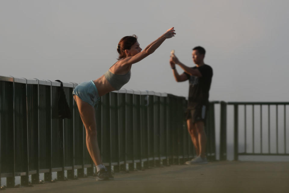 A woman exercises at a park in Singapore. 