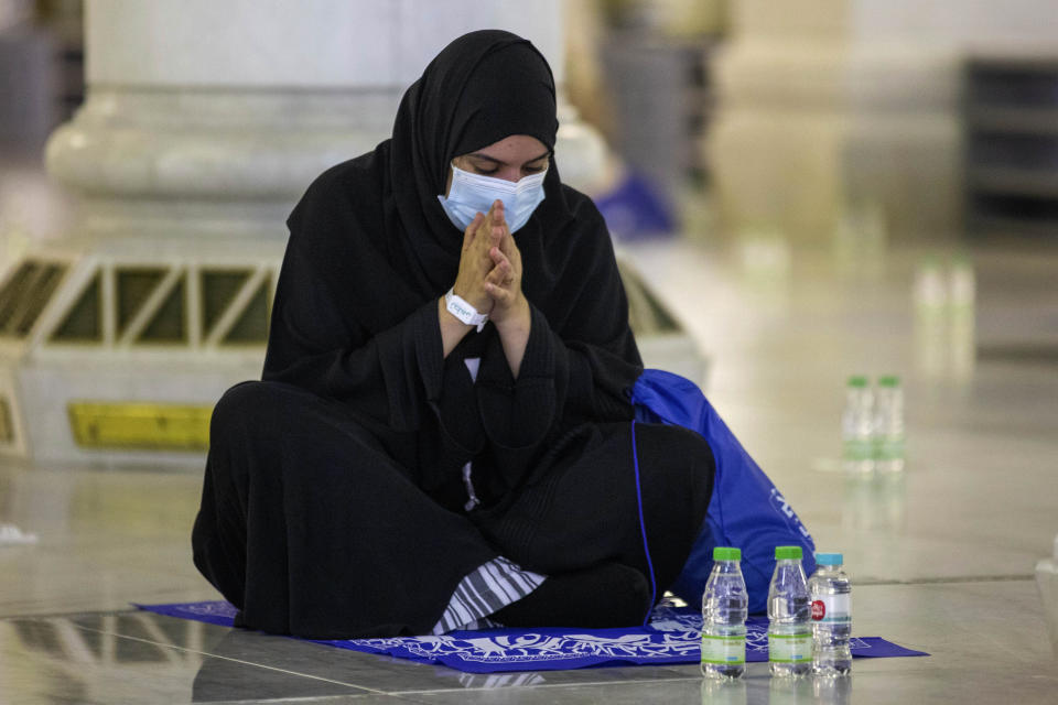 In this photo released by the Saudi Media Ministry, a limited numbers of pilgrims pray in the first rituals of the hajj, as they keep social distancing to limit exposure and the potential transmission of the coronavirus, at the Grand Mosque in the Muslim holy city of Mecca, Saudi Arabia, Wednesday, July 29, 2020. A unique and scaled-down hajj started on Wednesday. (Saudi Media Ministry via AP)