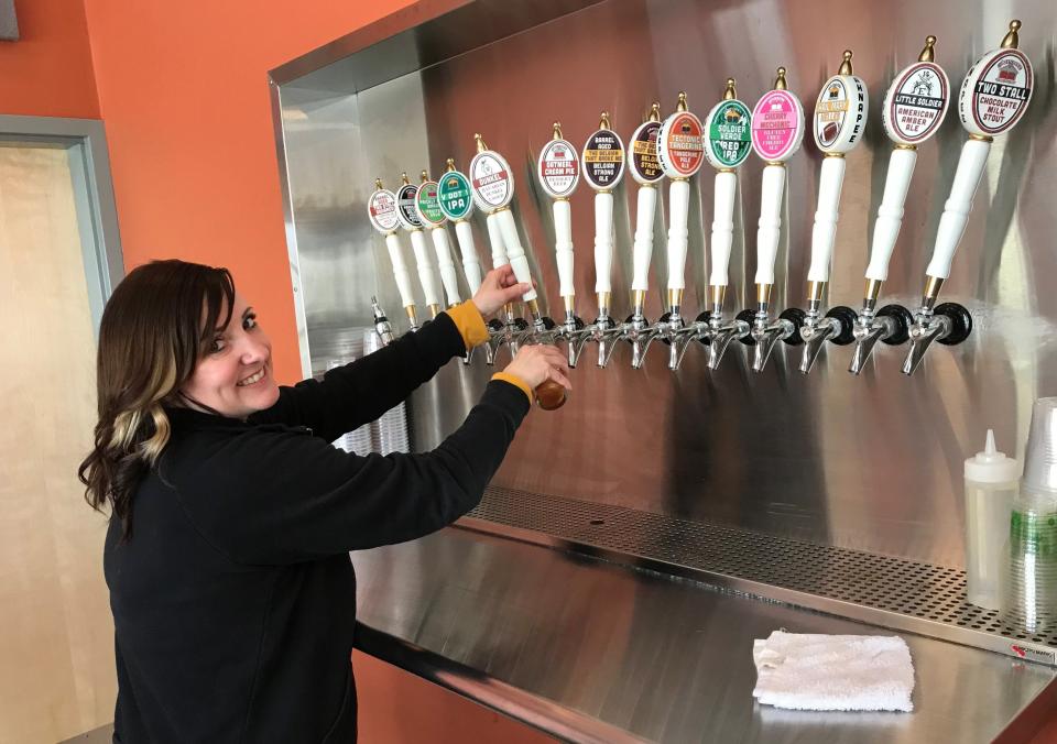 Taproom operation manager Lindsey Brehmer pours a Bavarian Dunkel from one of the 16 beer taps in Ahnapee Brewery's new Algoma taproom, which is holding a grand opening celebration Saturday, June 4.