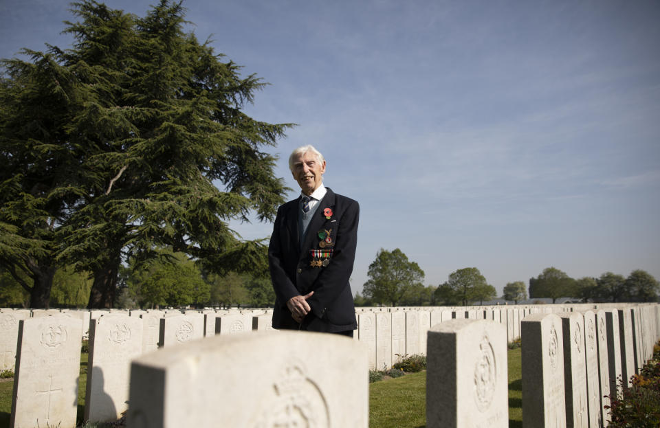 British RAF veteran George Sutherland, 98, poses for a photo at Lijssenthoek war cemetery prior to taking part in a VE Day charity walk to raise funds for Talbot House in Poperinge, Belgium, Friday, May 8, 2020. Sutherland segment walked from the Lijssenthoek war cemetery to Talbot house to raise money for the club which is currently closed due to coronavirus lockdown regulations. The club, founded in 1915 was a place for British soldiers to rest during both the First and Second World Wars. (AP Photo/Virginia Mayo)