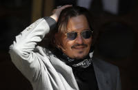 US Actor Johnny Depp arrives at the High Court in London in London, Tuesday, July 28, 2020. Hollywood actor Johnny Depp is suing News Group Newspapers over a story about his former wife Amber Heard, published in The Sun in 2018 which branded him a 'wife beater', a claim he denies.(AP Photo/Frank Augstein)