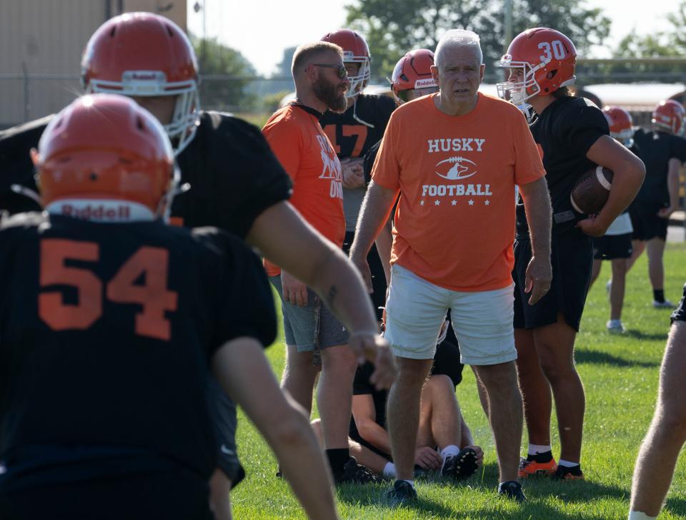 Assistant coach Chuck Reeves takes mental notes on players during football practice Monday, Aug. 28, 2023, at Hamilton Heights High School on in Arcadia. This season will be Reeves’ 43rd and final season with the Huskies football program.