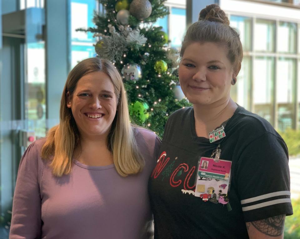 Samantha Alten and Nurse Nicole Kraft pose together on Dec. 14 in Aurora Medical Center. Kraft is wearing her decorated identification badge and a winter NICU shirt she had for the winter holiday season.