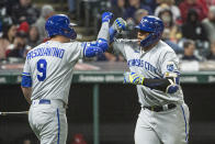 Kansas City Royals' Vinnie Pasquantino congratulates Salvador Perez after his solo home run off Cleveland Guardians relief pitcher Kirk McCarty during the seventh inning of a baseball game in Cleveland, Saturday, Oct. 1, 2022. (AP Photo/Phil Long)