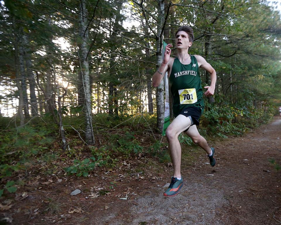 Marshfield's Tyler McCredie sprints to the finish line to take first overall with a time of 16:46.43 in their meet against Hingham at Marshfield High on Wednesday, Oct. 12, 2022. Marshfield girls would win 19-39 while Marshfield boys won 19-44.